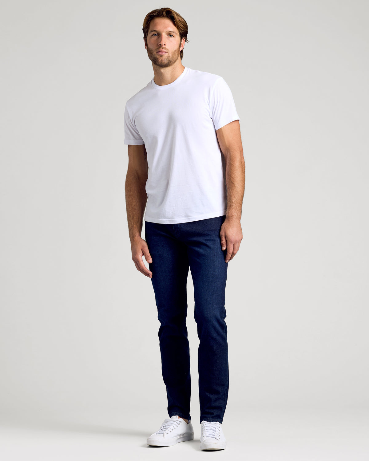 Man wearing Indigo Rinse Slim Authentic Denim Jeans with white T-shirt.