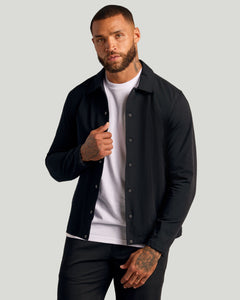 True ClassicBlack Coaches Jacket on young man, showcasing slim fit and snap closure.