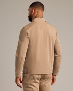 True ClassicMan wearing Khaki Coaches Jacket and matching trousers, facing away.