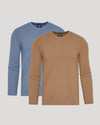 Two long-sleeve crew-neck knit shirts shown on a light gray background, with one in tan/camel in front and one in dusty blue behind.