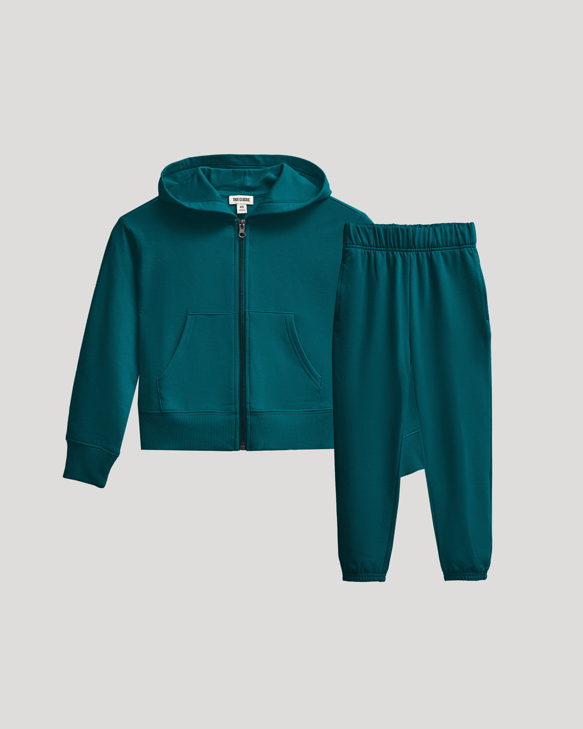 Girls Deep Emerald Cropped Zip Hoodie & Relaxed Joggers laid flat.