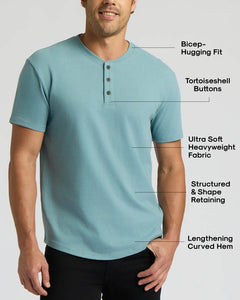 True ClassicMan wearing a light blue Citadel Heavyweight Curved Hem Henley with bicep-hugging fit, tortoiseshell buttons, ultra-soft heavyweight fabric, structured shape, and a lengthening curved hem.