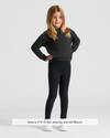 Girl wearing Girls Black Slouch Pullover Crew with leggings and sneakers.
