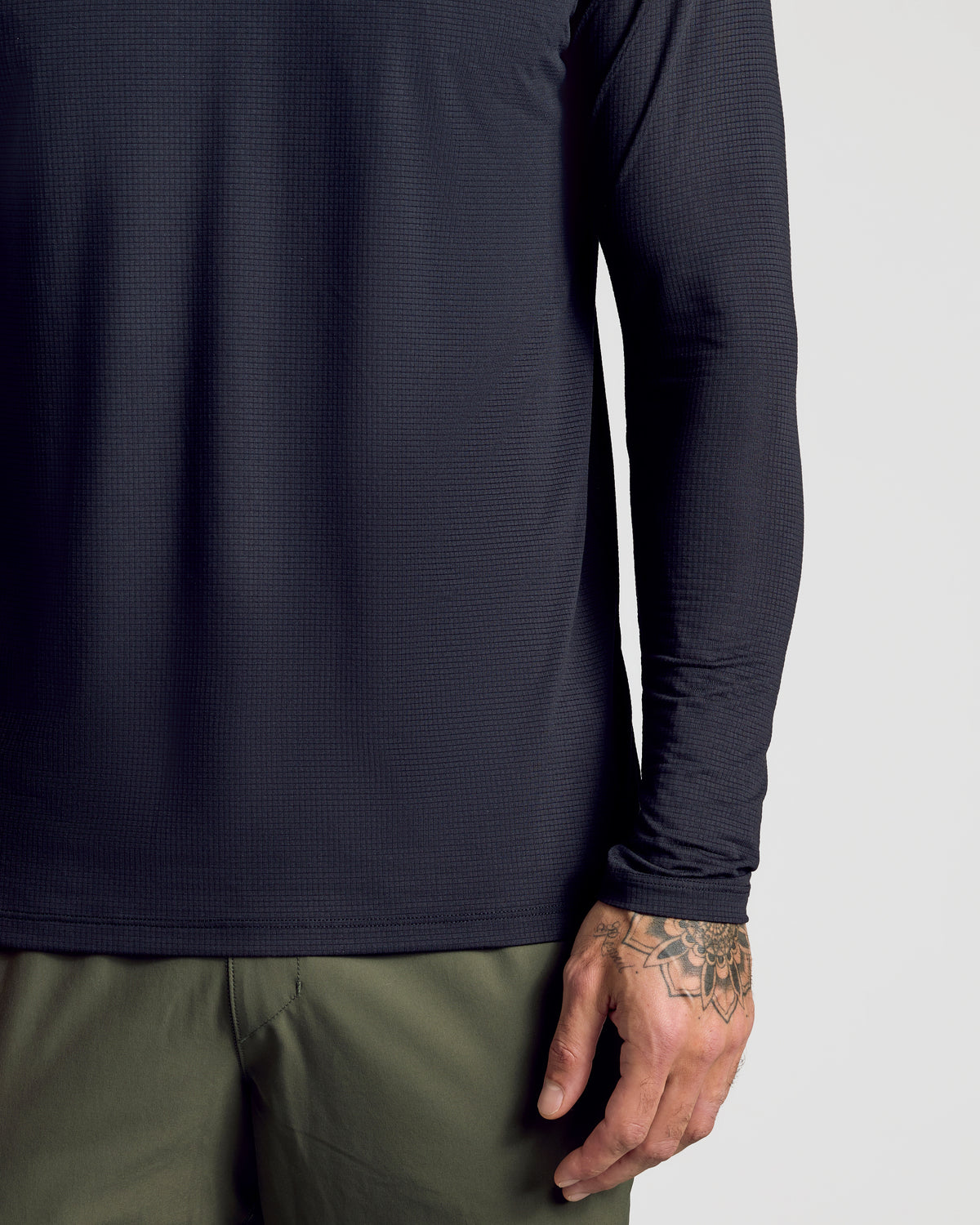 Black Long Sleeve Active Mesh Crew with tattooed hand visible.