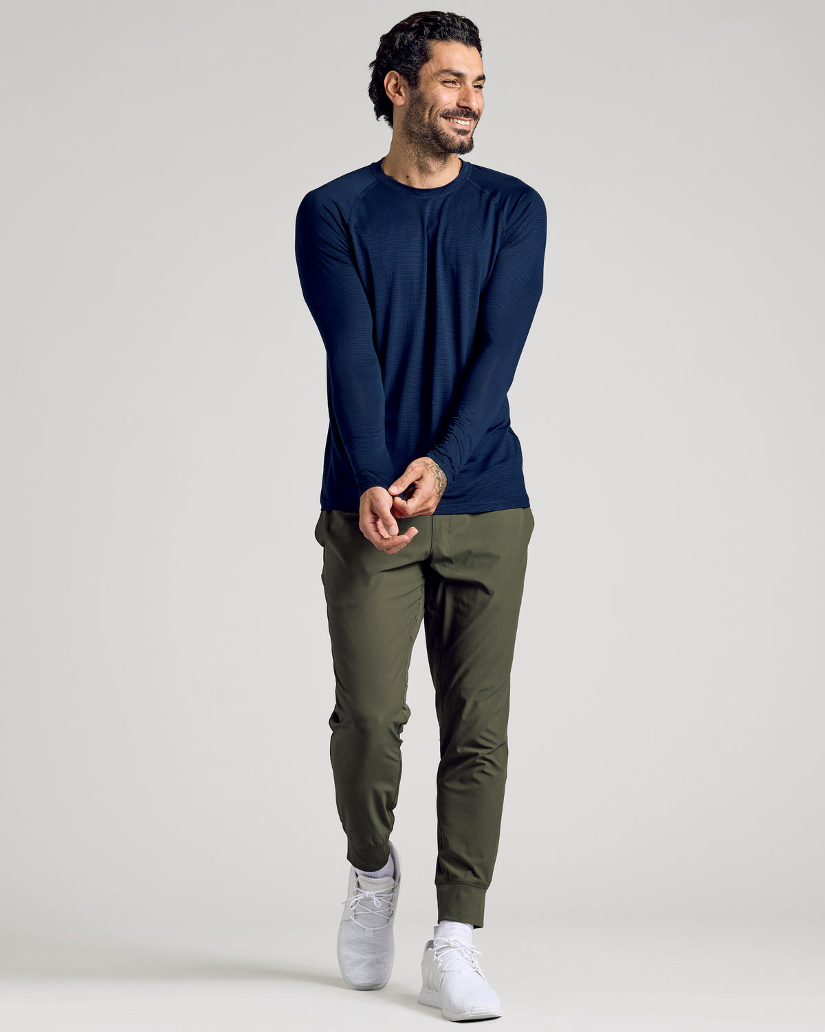 Man wearing Navy Long Sleeve Active Mesh Crew adjusting sleeve.