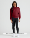 Child wearing Girls Dark Maroon Slouch Pullover Crew with black leggings.