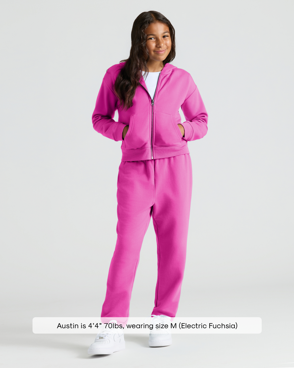 Child wearing Girls Electric Fuchsia Relaxed Joggers with matching hoodie.