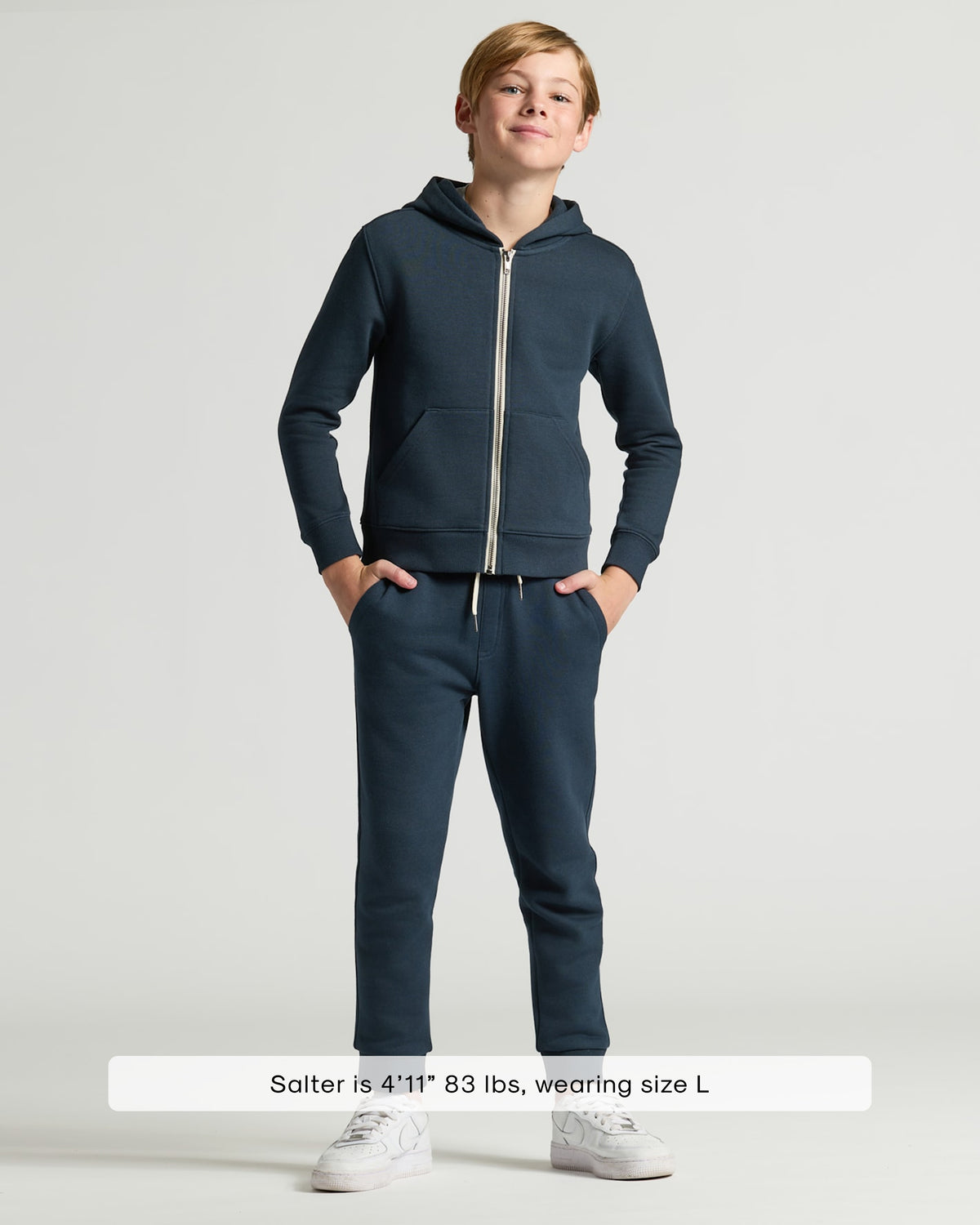 Boy wearing Boys' Navy Fleece Full Zip Hoodie with matching joggers.