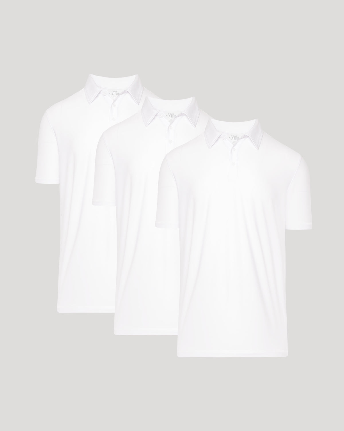 True Classic Men’s Active Short Sleeve Polo - Moisture Wicking Golf Shirt with Stretch Fit, Casual Menswear for Workwear, Blue Collar, or Gifts, three white polos displayed together