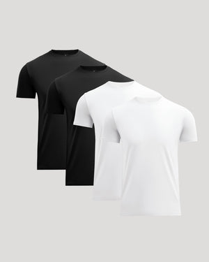 Four crew neck t-shirts in black and white arranged in a staggered formation, representing the Black & White Pima Cotton Blend Crew 4-Pack men's basics by True Classic.