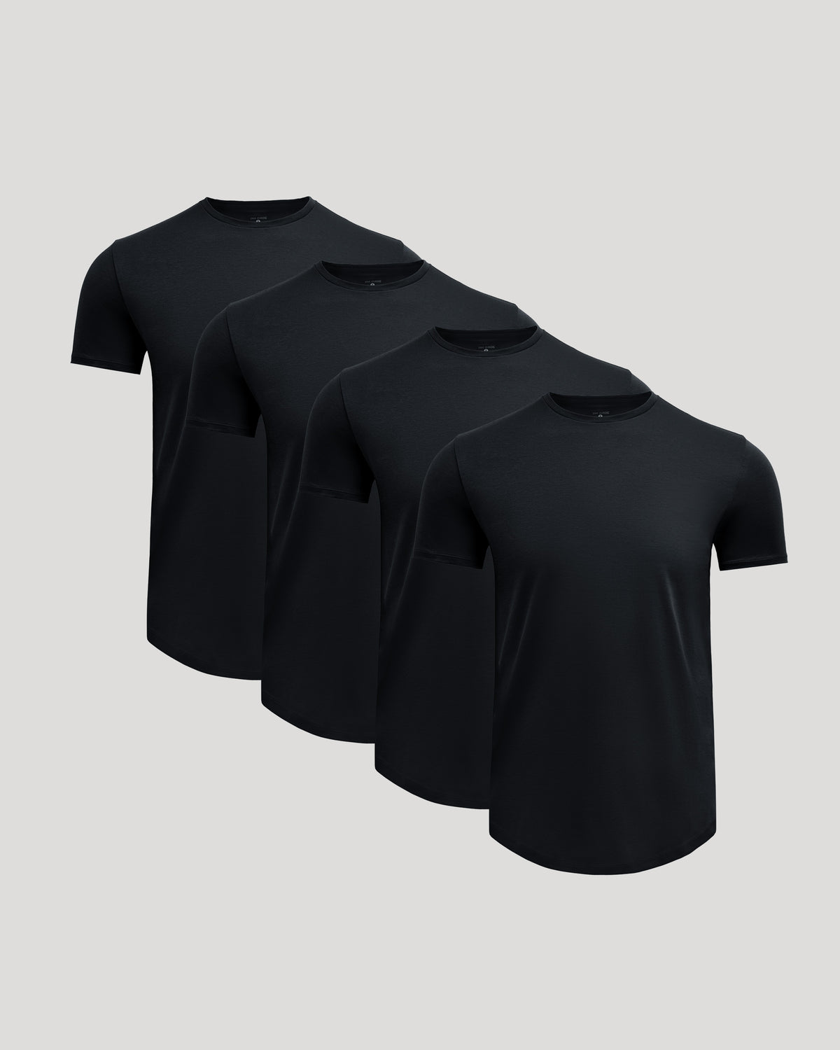 Four black crew neck t-shirts arranged in a row showcasing the Pima Cotton Blend Curved Hem Crew 4-Pack, a men's basics essential by True Classic.