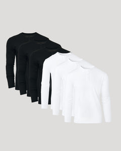 True ClassicThree black long-sleeve shirts and one white long-sleeve shirt on a light gray background