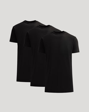 Three black t-shirts stacked on a light gray background