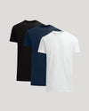 Three plain t-shirts in black, navy, and white on a light gray background