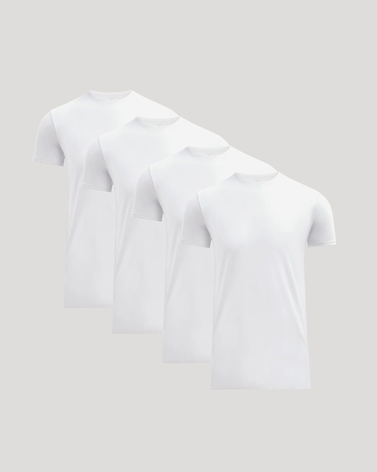 Four plain white crew neck t-shirts neatly arranged, showcasing the Tall Pima Cotton Blend Crew 4-Pack as essential men's basics.