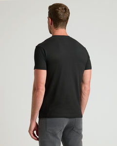 True ClassicMan wearing a black t-shirt and gray pants on a light gray background