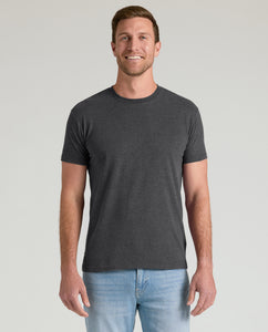 True ClassicMan wearing Charcoal Heather Gray Classic Crew Neck T-shirt and jeans, smiling.