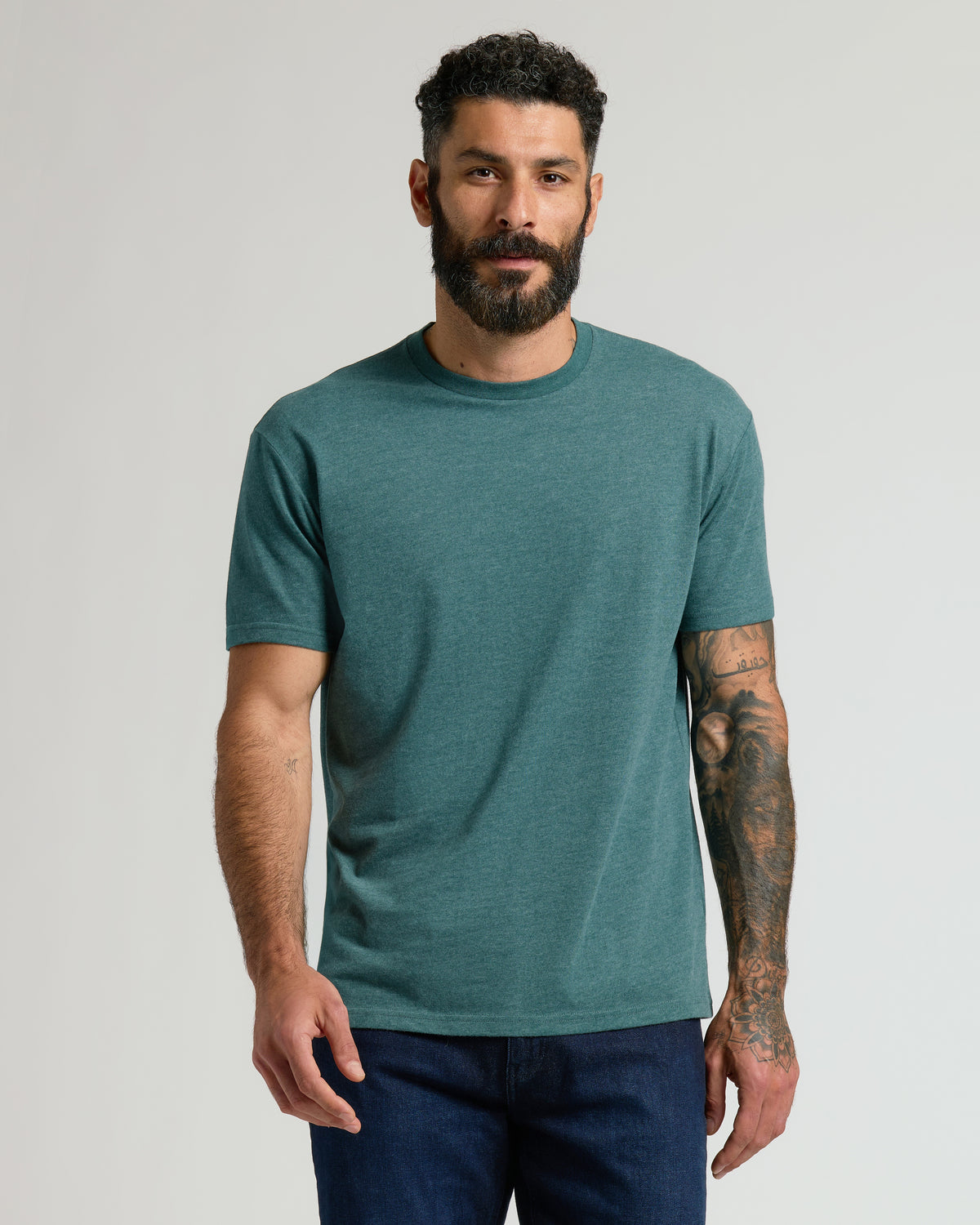 Man in Heather Seafarer Classic Crew Neck, showing tattooed arm.
