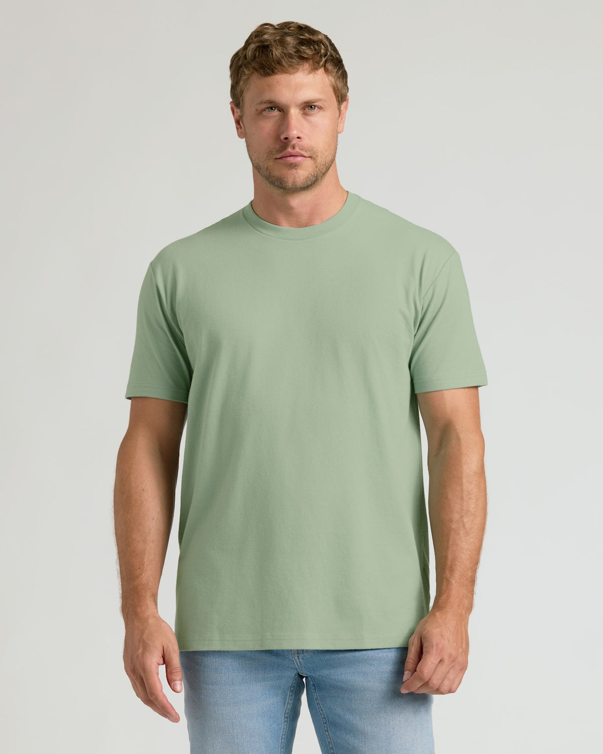 Man wearing a green t-shirt against a plain background