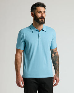 True ClassicHeather Voyager Short Sleeve Polo on man with tattooed arm.