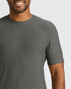 True ClassicA close-up of a man wearing a dark heather gray crew-neck t-shirt against a light gray background.