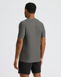 True ClassicA man viewed from behind wearing a dark heather gray short-sleeve t-shirt and black athletic shorts against a light gray studio background.