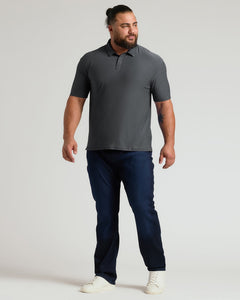True ClassicA confident man modeling a charcoal heather gray short-sleeve polo paired with dark jeans and white sneakers, showcasing the Charcoal Heather Gray Active Polo 2.0 in a casual stance.