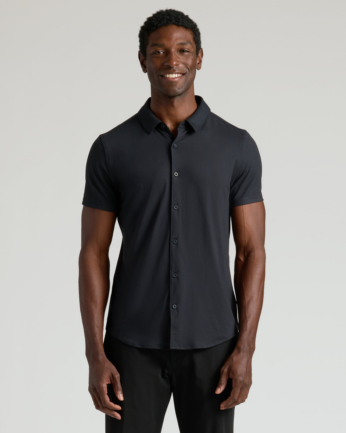 Man wearing Neutral Short Sleeve Comfort Knit Shirt, showcasing its sleek, casual style.