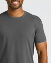 Man wearing a gray t-shirt against a plain background