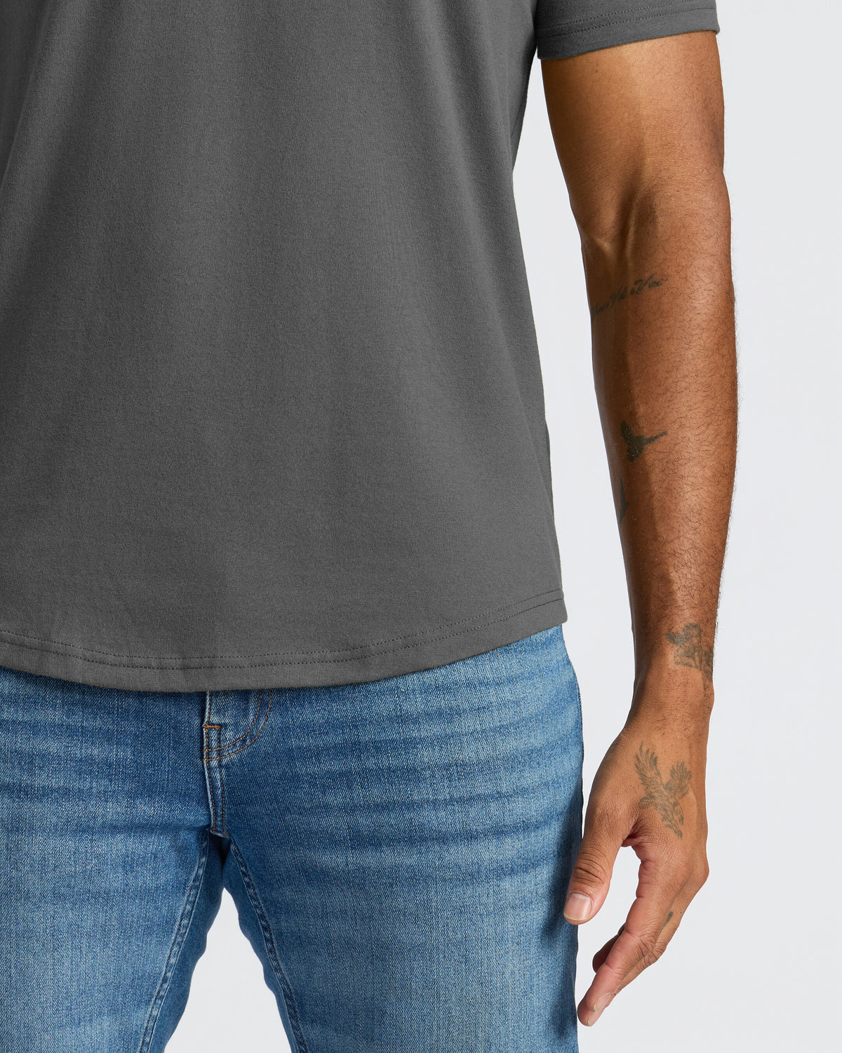 Carbon Curved Hem Classic Crew Neck on person with arm tattoos.