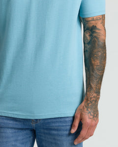 True ClassicHeather Voyager Classic V-Neck on tattooed forearm, showcasing fit and style.