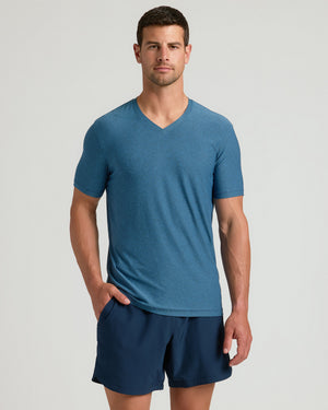 Man in Dark Heather Bluebird Active V-Neck and navy shorts.