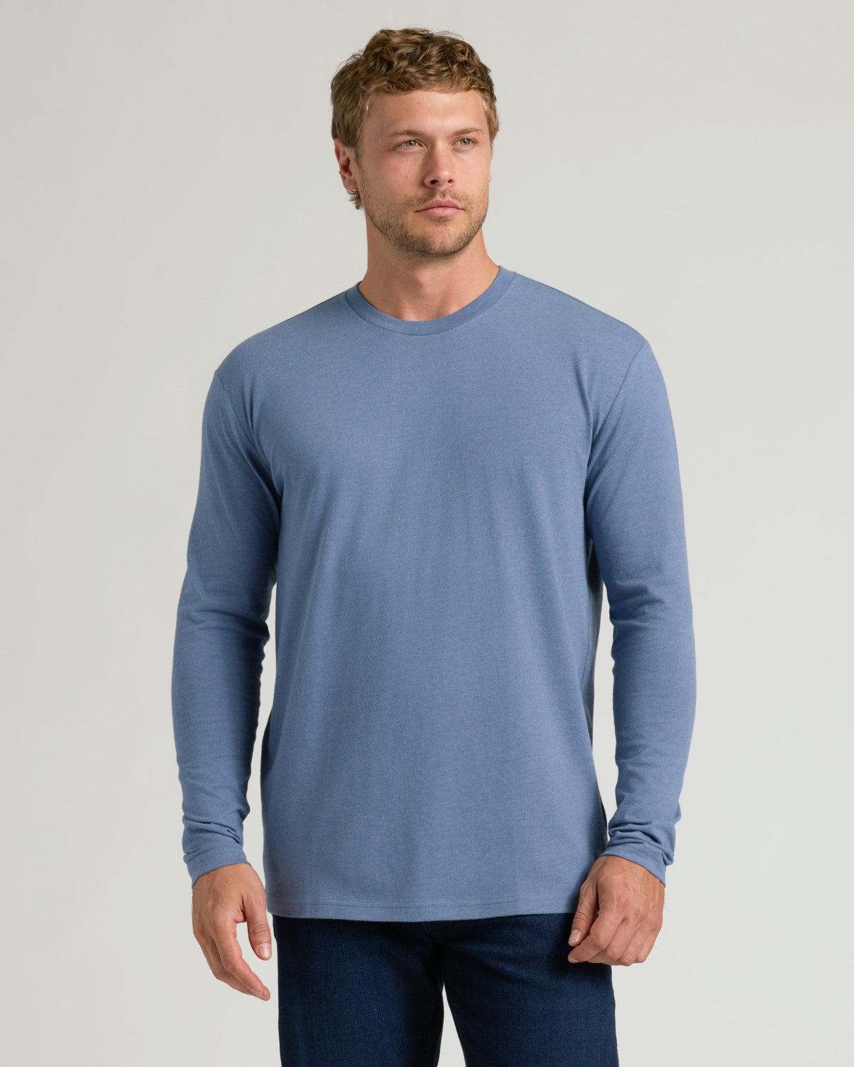 Man wearing Dark Heather Vintage Navy Classic Long Sleeve Crew Neck.