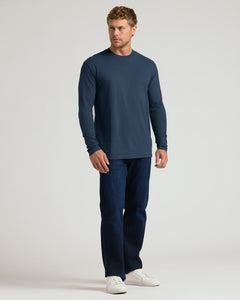 True ClassicMan wearing Navy Classic Long Sleeve Crew Neck, dark jeans, white sneakers.