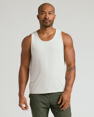 Man in Dove Sleeveless Active Mesh Tank, showcasing tattoos and athletic fit.