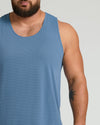 Man wearing Fiord Sleeveless Active Mesh Tank with tattooed forearm.