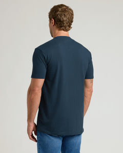 True ClassicBack view of model in Navy Pocket Crew Tee and medium-wash jeans.