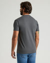 Back view of man in Carbon Heavyweight Pocket Crew with medium-wash jeans.