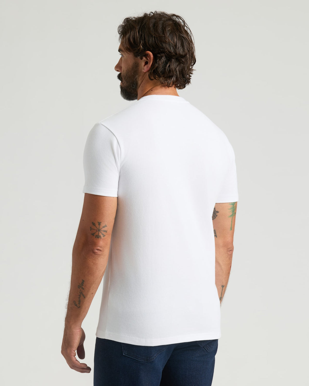 Man wearing All White Heavyweight Pocket Crew Neck, showcasing tattoos.