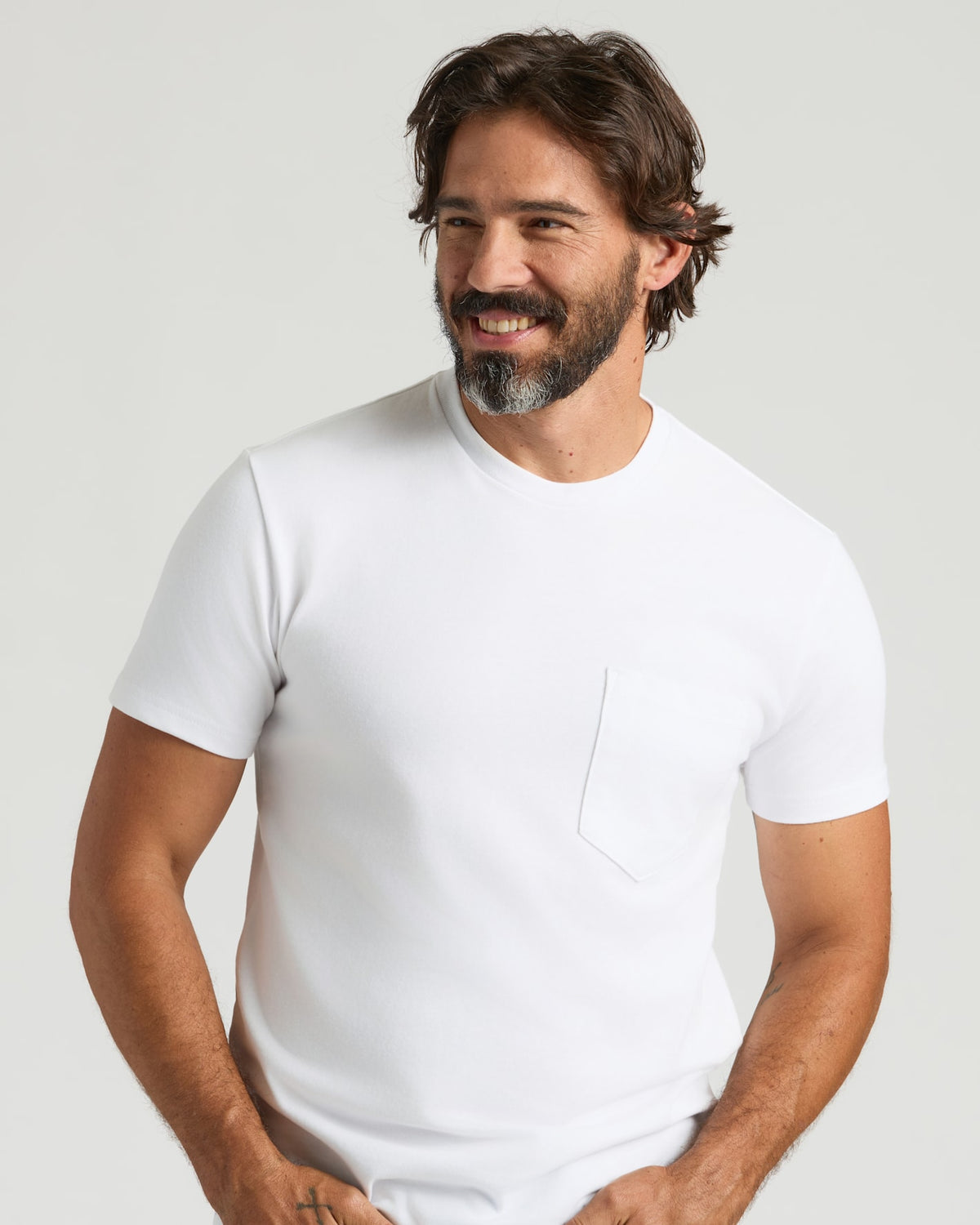 White Heavyweight Pocket Crew worn by smiling man with a relaxed pose.