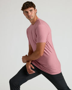 True ClassicQuartz Rose Tall Active Crew Neck 2.0 on young man, stretching pose.