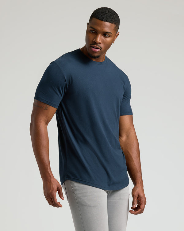Man wearing Wardrobe Classic Tall Curved Hem Crew T-shirt and slim-fit pants.