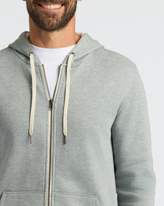 True ClassicA close-up of a man wearing a light gray heather zip-up hoodie over a white t-shirt, showing the front of the hoodie with its drawstrings and zipper.