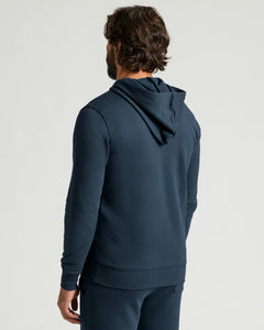 True ClassicNavy Fleece French Terry Pullover Hoodie shown from the back on a male model with a hood, long sleeves, and a relaxed fit for men's basics