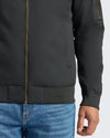 Black Bomber Jacket with brass zipper and ribbed hem, paired with jeans.