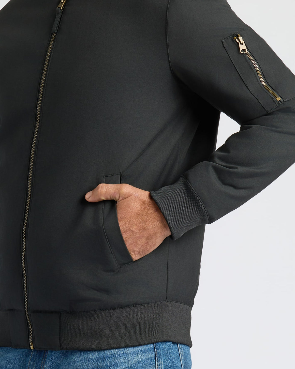 Black Bomber Jacket with brass zipper, ribbed cuffs, and sleeve pocket.