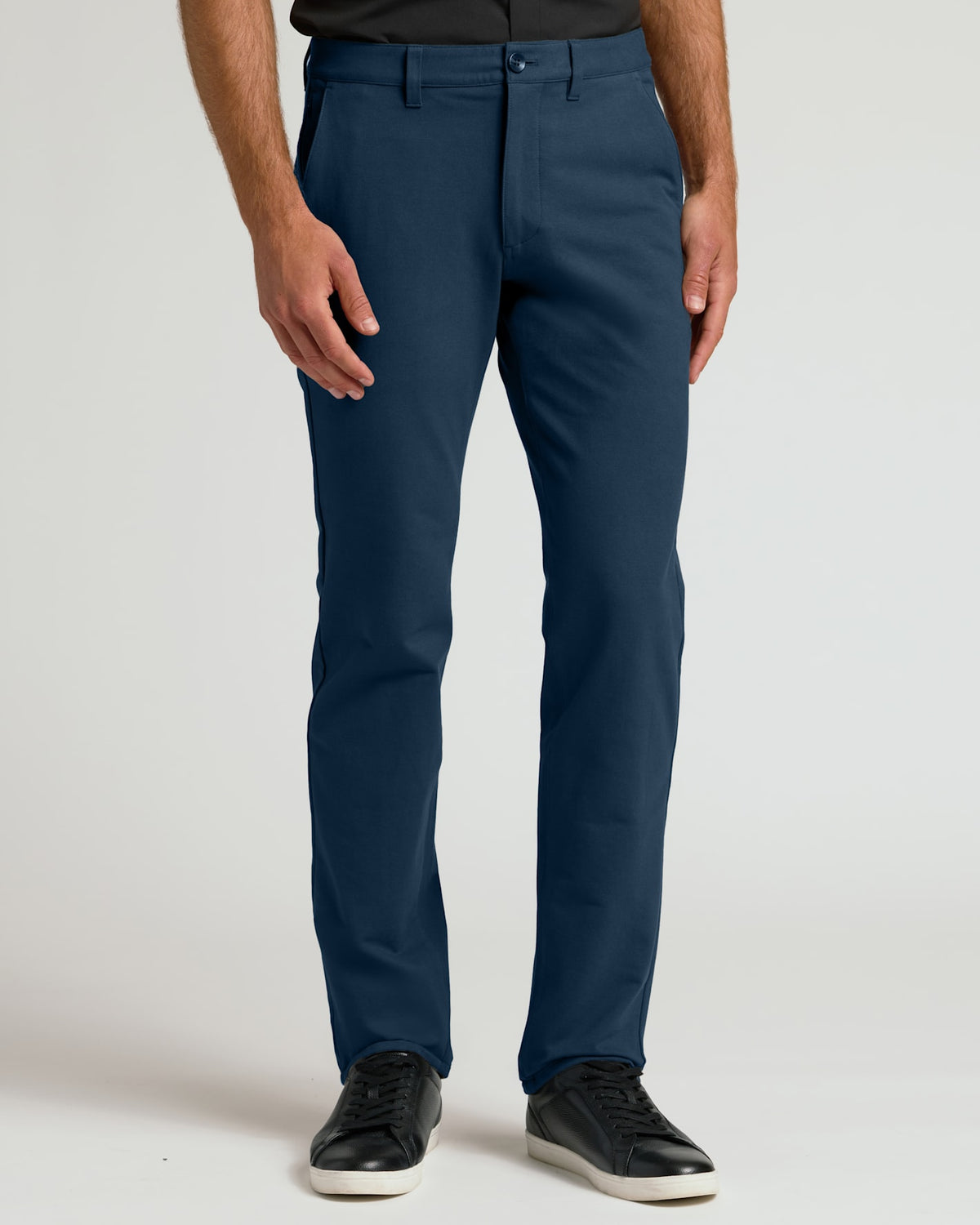 Model wearing Core Straight Chino Pants, navy, slim-fit, with black sneakers.