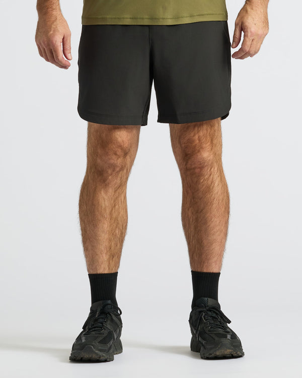 7 Black Active Training Shorts 2.0, worn with black socks and shoes.