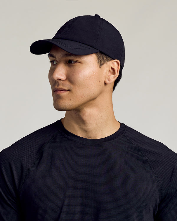 Black Active Running Cap on young man, slightly turned, looking off-camera.