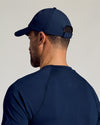 Man wearing Navy Active Running Cap with adjustable strap.